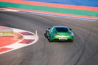 Beautiful Green Race Car Rides Along Race Track Wall Mural