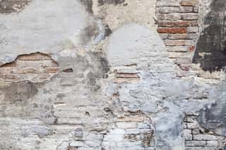 Old Brick Wall With Damaged Stucco And Paint Layers Wall Mural
