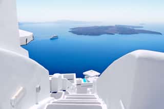 White Wash Staircases On Santorini Island, Greece  The View Toward Caldera Sea With Cruise Ship Awaiting  Wall Mural