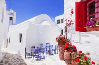 Traditional Greek Street With Flowers In Amorgos Island, Greece    Wall Mural