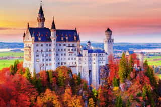 Germany  Famous Neuschwanstein Castle In The Background Of Trees With Yellow And Green Leaves And Valley  Wall Mural