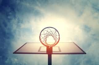 Basketball Hoop On Basketball Court Under Blue Sky With Clouds Wall Mural