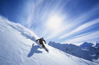 Full Length Of Skier Skiing On Fresh Powder Snow Wall Mural