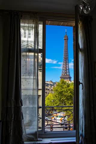 The Eiffel Tower Framed Through An Open Window In Paris, France Wall Mural