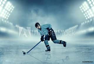 Ice Hockey Player In Equipment Poses On Stadium Wall Mural