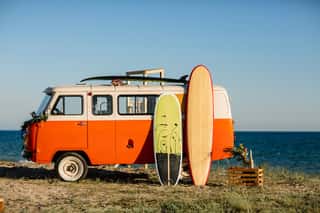 Bus With A Surfboard On The Roof Is A Parked Near The Beach    Wall Mural