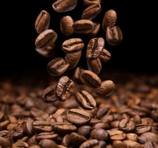 Falling Coffee Beans On Dark Background, Close-up Wall Mural