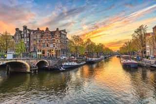 Amsterdam Sunset City Skyline At Canal Waterfront, Amsterdam, Netherlands Wall Mural
