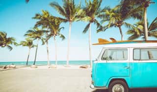 Vintage Car Parked On The Tropical Beach (seaside) With A Surfboard On The Roof - Leisure Trip In The Summer  Retro Color Effect Wall Mural