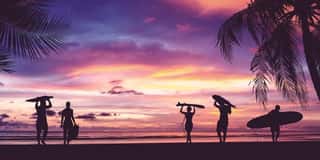 Silhouette Of Surfer People Carrying Surfboard Wall Mural