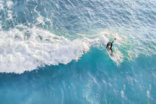 Surfer At The Top Of The Wave In The Ocean, Top View Wall Mural