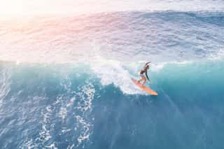 Surfer In The Ocean On A Sunny Day, Top View Wall Mural
