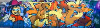 Street Art  Abstract Background Image Of A Full Completed Graffiti Painting In Beige And Orange Tones With Cartoon Character Wall Mural