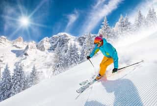 Skier Skiing Downhill In High Mountains   Wall Mural