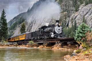 Steam Train Crossing A Trestle Bridge In The Mountains Wall Mural