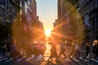 Sunlight Shines Over The Buildings And People Of A Busy Midtown Manhattan Street Scene In New York City Wall Mural