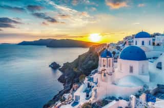 Beautiful View Of Churches In Oia Village, Santorini Island In Greece At Sunset, With Dramatic Sky  Wall Mural
