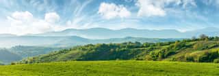 Panorama Of Beautiful Countryside Of Romania  Sunny Afternoon  Wonderful Springtime Landscape In Mountains  Grassy Field And Rolling Hills  Rural Scenery Wall Mural