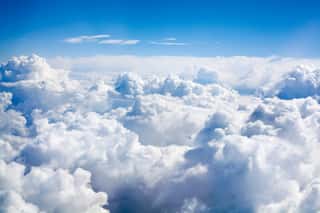 White Clouds On Blue Sky Background Close Up, Cumulus Clouds High In Azure Skies View From Airplane Wall Mural