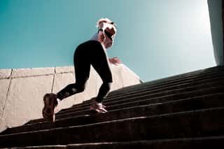 Sporty Lady Running Up The Stairs Outdoors Wall Mural