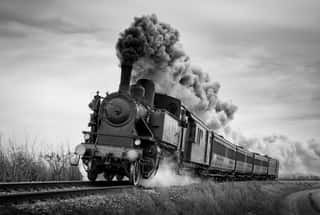 Steam Train Runs On The Tracks On A Cloudy Day  Black And White Photography  Wall Mural