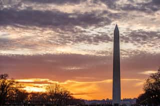 Washington Monument At Sunset With Orange Clouds In The Background Wall Mural