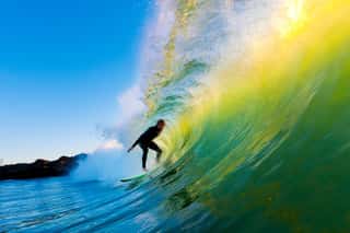 Surfer On Wave At Sunset Wall Mural