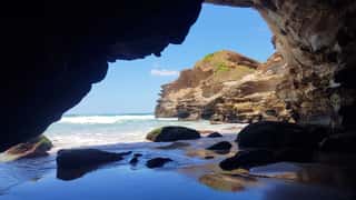 The Entrance To The Rainbow Cave At Ghosties Beach Near Catherine Hill Bay New South Wales Australia  A Sea Cave With Amazing Colours In Its Rocks Wall Mural