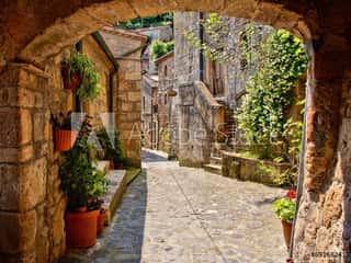 Arched Cobblestone Street In A Tuscan Village, Italy Wall Mural