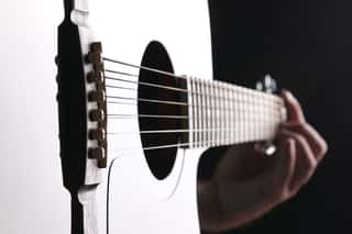 Acoustic Guitar Close-up With Fingers Playing It Wall Mural