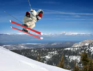 A Young Man Jumping High At Lake Tahoe Resort Wall Mural