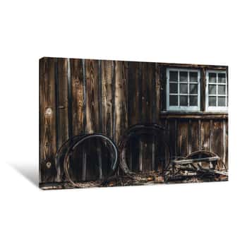 Image of Metal Rings Leaning Against Barn Canvas Print