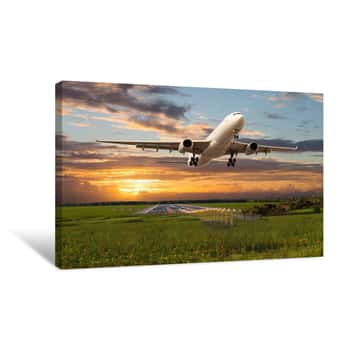 Image of Passenger Plane Takes Off From The Airport Runway During The Sunset  Canvas Print
