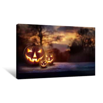 Image of A Woodland Sunset With The Spooky Evil Glowing Eyes Of Jack O\' Lanterns On Halloween Canvas Print