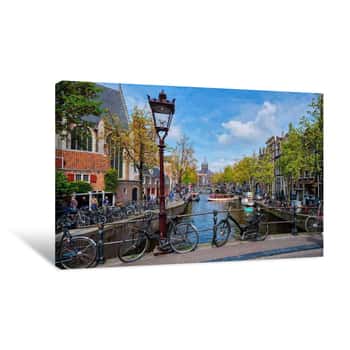 Image of Bicycles In Amsterdam Street Near Canal With Old Houses Canvas Print