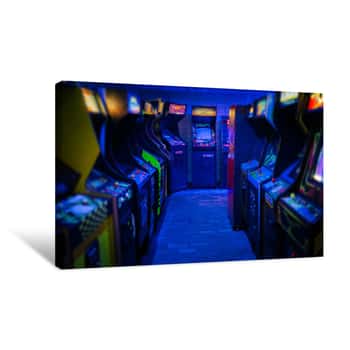Image of Old Vintage Arcade Video Games In An Empty Dark Gaming Room With Blue Light With Glowing Displays And Beautiful Retro Design Canvas Print