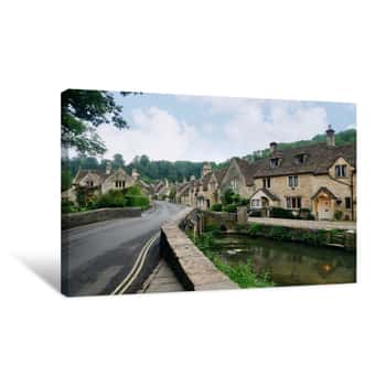 Image of View Of Buildings Against Cloudy Sky In Castle Combe, Wiltshire Canvas Print