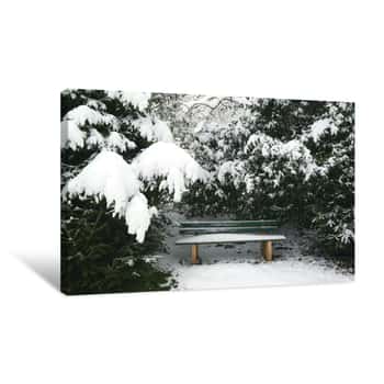Image of Snowcapped Park Bench And Trees During Winter Canvas Print