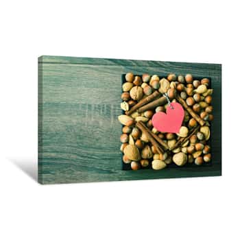 Image of Paper Heart Shape On Nuts Background, Top View Canvas Print
