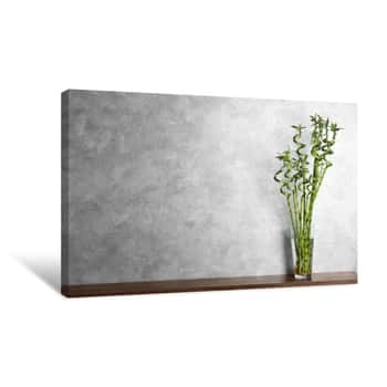 Image of Table With Bamboo Plant In Glass Vase Near Color Wall  Space For Text Canvas Print