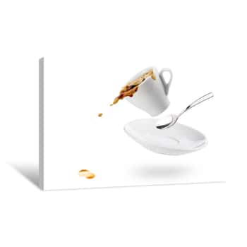 Image of Cup Of Coffee Spils With Saucer And Spoon And Coffee Falls On White Background Canvas Print