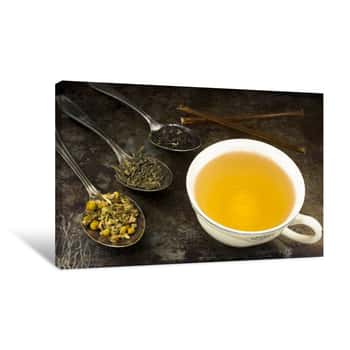 Image of Cup Of Tea With Leaves And Honey / A Cup Of Brewed Green Tea With Honey Sticks And Loose Leaf Tea Leaves Canvas Print