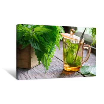 Image of Healthy Nettle Tea Or Infusion And Nettle Herbs On Wooden Table In Retro Village House Canvas Print