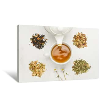 Image of Pouring Tisane Into Cup With Variety Of Herbal Tea On Table Canvas Print