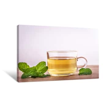 Image of Close Up A Glass Cup Of Mint Tea With Green Fresh Peppermint Leaves , Relaxation And Healthy Drink Canvas Print