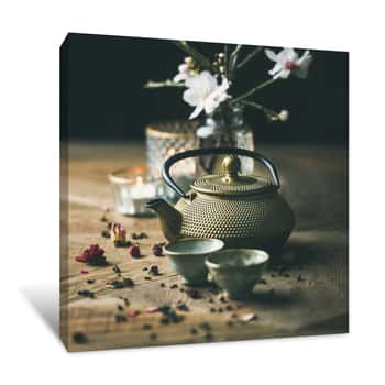 Image of Traditional Asian Tea Ceremony Arrangement  Golden Iron Teapot, Cups, Candles And Almond Blossom Flowers Over Vintage Wooden Table Background, Selective Focus, Square Crop Canvas Print