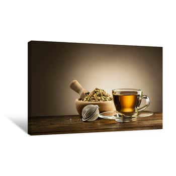 Image of Glass Cup Of Tea With Infuser And Herbal Tea On Wooden Table Canvas Print