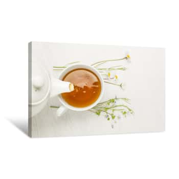 Image of Pouring Herbal Tea Into Cup On White Table Canvas Print