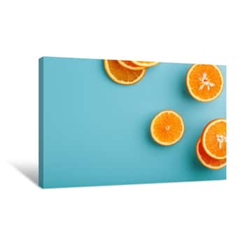 Image of Slices And Slices Of Orange Pulp On A Bright Blue Background As A Textural Background, The Substrate  Full Screen Flat Lay, Top View  Food Background Canvas Print