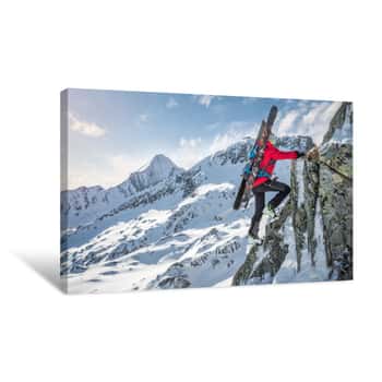 Image of Mountaineer With Skiers Climbing Up A Rock In The Mountains In Winter Canvas Print